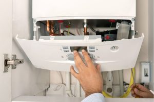 Technician closing boiler door